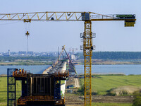 Workers are carrying out the construction of the steel pier bridge and the lower structure of the bridge across three river sections at the...