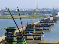 Workers are carrying out the construction of the steel pier bridge and the lower structure of the bridge across three river sections at the...