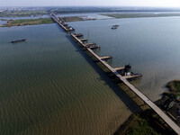 Workers are carrying out the construction of the steel pier bridge and the lower structure of the bridge across three river sections at the...