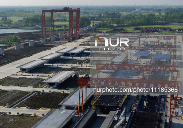 Workers are carrying out the construction of the steel pier bridge and the lower structure of the bridge across three river sections at the...