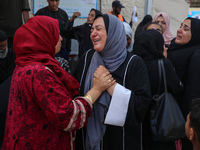 Palestinians are mourning by the bodies of relatives who were killed in an Israeli bombardment, at the al-Aqsa hospital in Deir Balah in the...