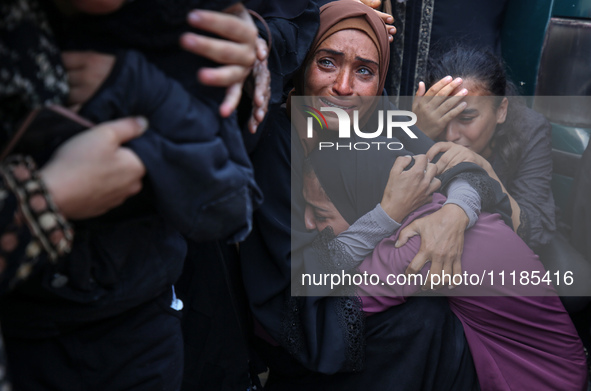 Palestinians are mourning by the bodies of relatives who were killed in an Israeli bombardment, at the al-Aqsa hospital in Deir Balah in the...