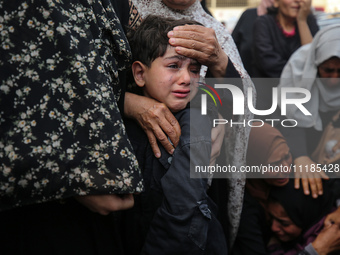 Palestinians are mourning by the bodies of relatives who were killed in an Israeli bombardment, at the al-Aqsa hospital in Deir Balah in the...