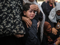 Palestinians are mourning by the bodies of relatives who were killed in an Israeli bombardment, at the al-Aqsa hospital in Deir Balah in the...