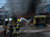 Firefighters are dousing flames as a fire spreads from a vehicle workshop to adjacent shops in Sankhamul, Kathmandu, causing extensive damag...