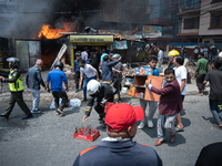 Shop owners are salvaging belongings as a fire spreads from a vehicle workshop to adjacent shops in Sankhamul, Kathmandu, causing extensive...