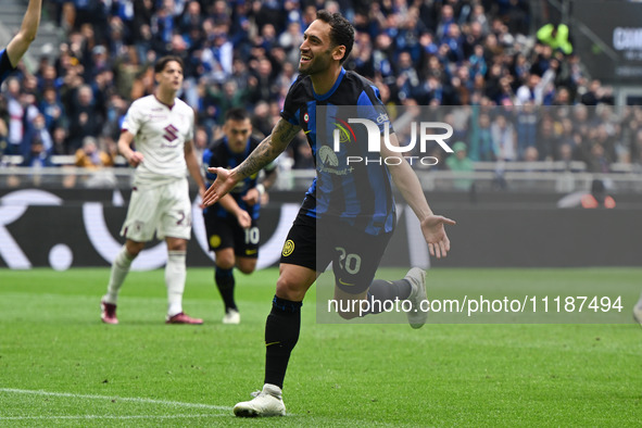 Hakan Calhanoglu of FC Inter is celebrating after scoring a goal during the Italian Serie A football match between Inter FC Internazionale a...