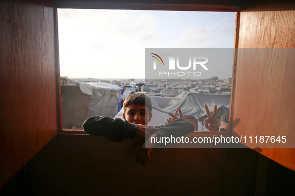 Palestinian children are attending class at a makeshift school in a camp for displaced Palestinians in Deir El-Balah, in the central Gaza St...