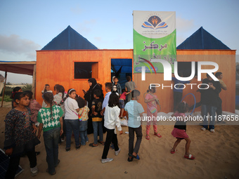 Palestinian children are attending class at a makeshift school in a camp for displaced Palestinians in Deir El-Balah, in the central Gaza St...