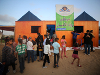 Palestinian children are attending class at a makeshift school in a camp for displaced Palestinians in Deir El-Balah, in the central Gaza St...