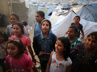 Palestinian children are attending class at a makeshift school in a camp for displaced Palestinians in Deir El-Balah, in the central Gaza St...