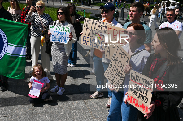 Participants are holding placards in support of the military held in Russian captivity during the FreeAzov action at the Taras Shevchenko mo...