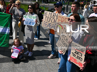 Participants are holding placards in support of the military held in Russian captivity during the FreeAzov action at the Taras Shevchenko mo...