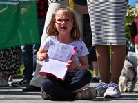 A girl is holding a copybook with a slogan written in it during the FreeAzov action in support of the military held in Russian captivity, at...