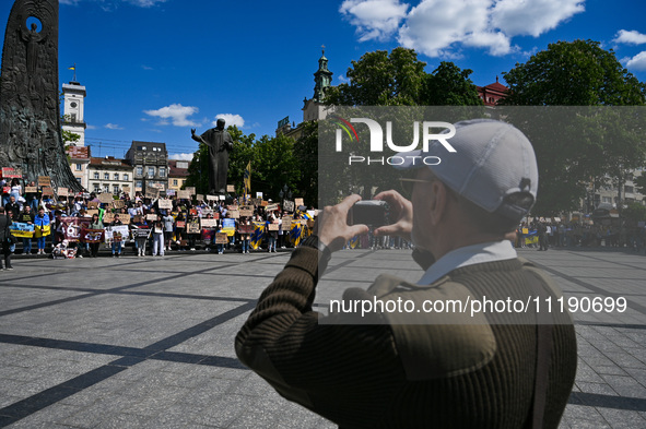 Participants are holding placards in support of the military held in Russian captivity during the FreeAzov action at the Taras Shevchenko mo...