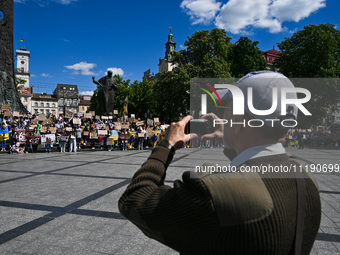 Participants are holding placards in support of the military held in Russian captivity during the FreeAzov action at the Taras Shevchenko mo...