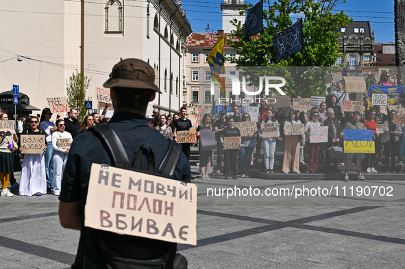 Participants are holding placards in support of the military held in Russian captivity during the FreeAzov action at the Taras Shevchenko mo...