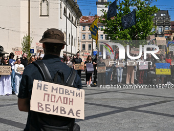 Participants are holding placards in support of the military held in Russian captivity during the FreeAzov action at the Taras Shevchenko mo...