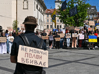 Participants are holding placards in support of the military held in Russian captivity during the FreeAzov action at the Taras Shevchenko mo...