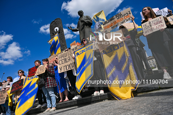 Participants are holding placards in support of the military held in Russian captivity during the FreeAzov action at the Taras Shevchenko mo...