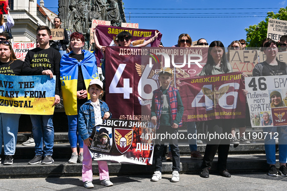 Participants are holding placards in support of the military held in Russian captivity during the FreeAzov action at the Taras Shevchenko mo...