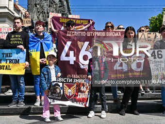 Participants are holding placards in support of the military held in Russian captivity during the FreeAzov action at the Taras Shevchenko mo...