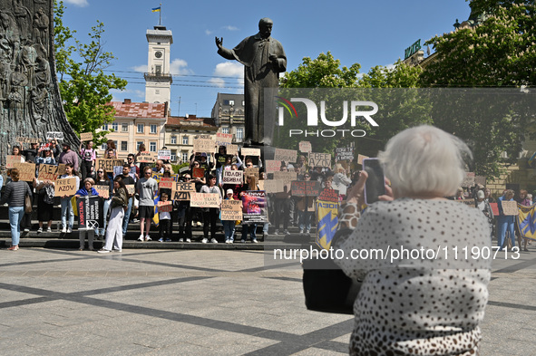 Participants are holding placards in support of the military held in Russian captivity during the FreeAzov action at the Taras Shevchenko mo...