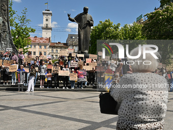 Participants are holding placards in support of the military held in Russian captivity during the FreeAzov action at the Taras Shevchenko mo...