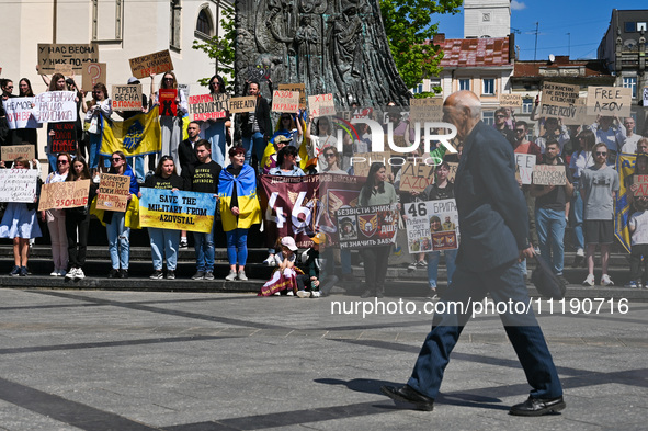 Participants are holding placards in support of the military held in Russian captivity during the FreeAzov action at the Taras Shevchenko mo...