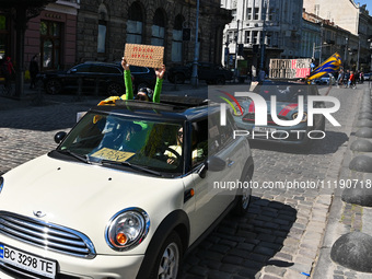 People in cars are holding placards during the FreeAzov action in support of the military held in Russian captivity in Lviv, Ukraine, on Apr...