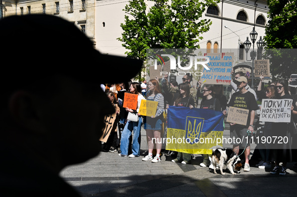 Participants are holding flags and placards in support of the military held in Russian captivity during the FreeAzov action at the square by...