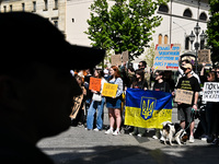 Participants are holding flags and placards in support of the military held in Russian captivity during the FreeAzov action at the square by...