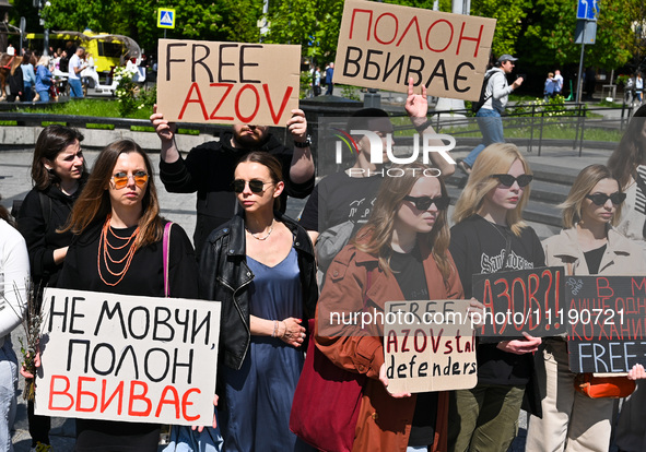 Participants are holding placards at the Taras Shevchenko monument in Lviv, Ukraine, on April 28, 2024, during the FreeAzov action in suppor...