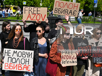 Participants are holding placards at the Taras Shevchenko monument in Lviv, Ukraine, on April 28, 2024, during the FreeAzov action in suppor...