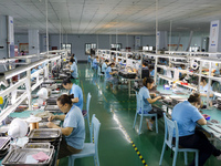 A worker is producing electronic products at a workshop in Nanchong, Sichuan Province, China, on April 29, 2024. (