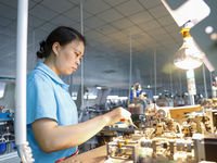 A worker is producing electronic products at a workshop in Nanchong, Sichuan Province, China, on April 29, 2024. (