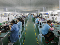 A worker is producing electronic products at a workshop in Nanchong, Sichuan Province, China, on April 29, 2024. (