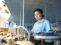 A worker is producing electronic products at a workshop in Nanchong, Sichuan Province, China, on April 29, 2024. (