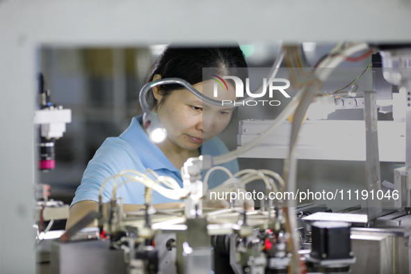 A worker is producing electronic products at a workshop in Nanchong, Sichuan Province, China, on April 29, 2024. 