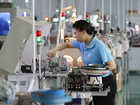 A worker is producing electronic products at a workshop in Nanchong, Sichuan Province, China, on April 29, 2024. (