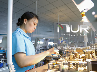 A worker is producing electronic products at a workshop in Nanchong, Sichuan Province, China, on April 29, 2024. (