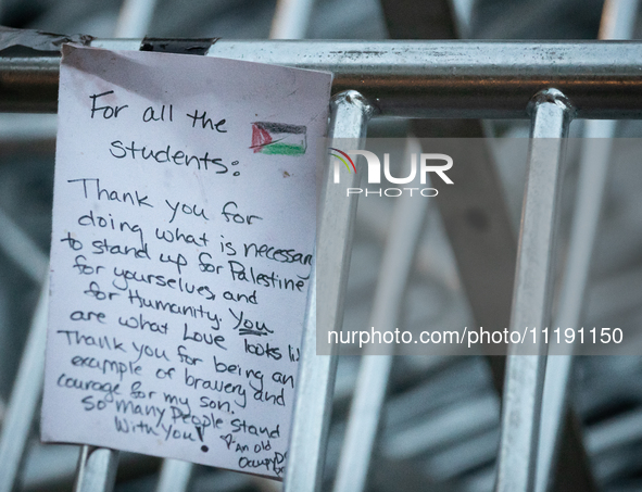 A thank you-note for students hangs on a barricade as the sun rises on the Gaza solidarity encampment at George Washington University, Washi...