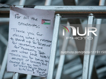 A thank you-note for students hangs on a barricade as the sun rises on the Gaza solidarity encampment at George Washington University, Washi...