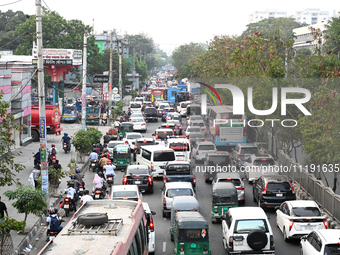 Commuters in Bangladesh are sitting in a traffic jam along a main road during a heatwave in Dhaka on April 29, 2024. (