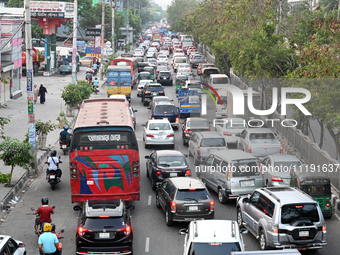 Commuters in Bangladesh are sitting in a traffic jam along a main road during a heatwave in Dhaka on April 29, 2024. (