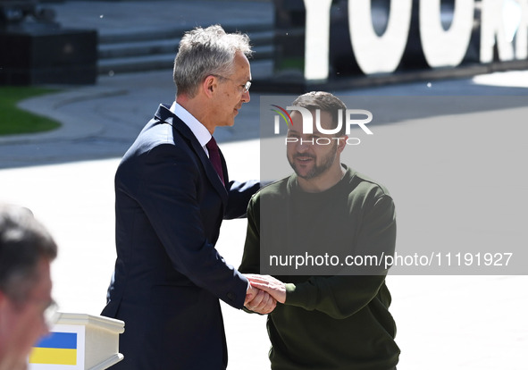 NATO Secretary General Jens Stoltenberg (L) and President of Ukraine Volodymyr Zelensky (R) shake hands after at a press conference followin...