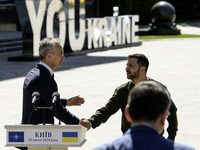 Ukraine's President Volodymyr Zelenskiy and NATO Secretary-General Jens Stoltenberg shake hands after a joint press conference, amid Russia'...