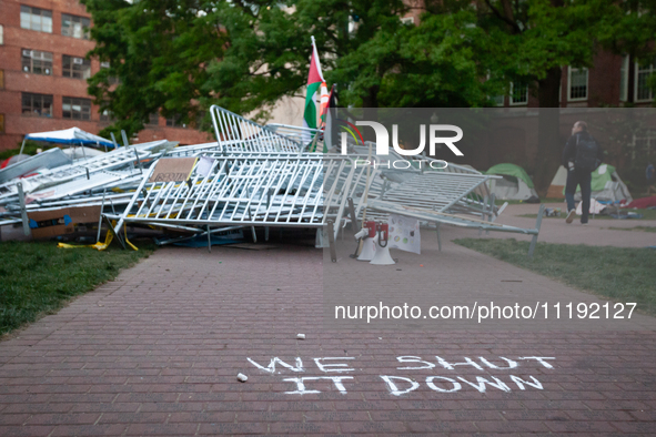 A chalk sign declares ''we shut it down'' in front of a pile of barricades in the center of the Gaza solidarity encampment at George Washing...