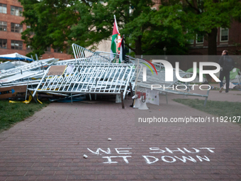 A chalk sign declares ''we shut it down'' in front of a pile of barricades in the center of the Gaza solidarity encampment at George Washing...