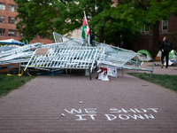 A chalk sign declares ''we shut it down'' in front of a pile of barricades in the center of the Gaza solidarity encampment at George Washing...